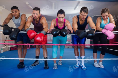 Preview: Exhausted Young Boxers Leaning On Rope In Boxing Ring