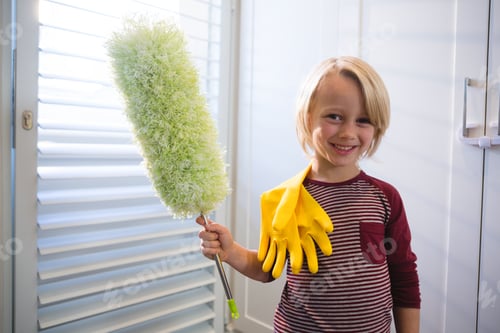 Preview: Portrait Of Boy Holding A Mop At Home