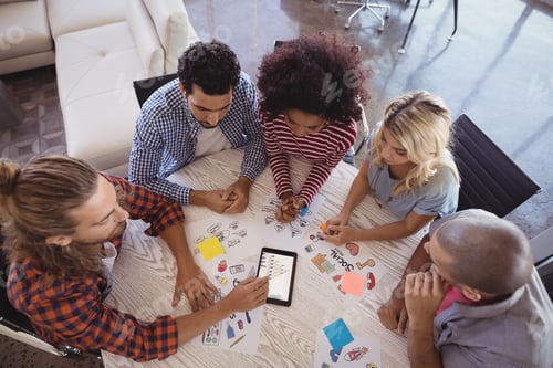 Preview: Overhead View Of Business Team Working Together At Creative Office Desk