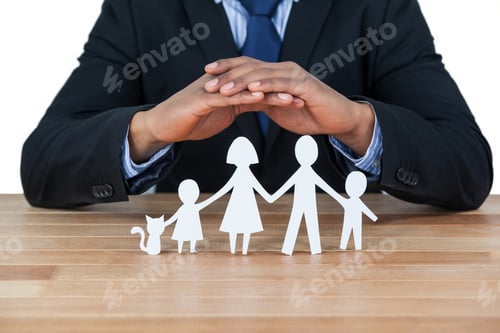 Preview: Mid Section Of Businessman Protecting Paper Cut Out Family, House And Car With Hands