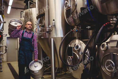 Preview: Brewery Worker Carrying Kegs At Factory
