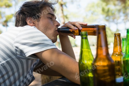 Preview: Unconscious Man Drinking Beer From Bottle In The Park