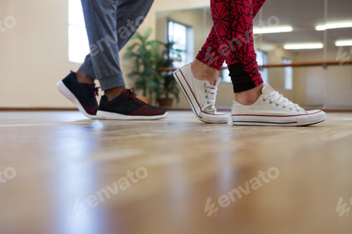 Preview: Low Section Of Man With Friend Rehearsing Dance On Hardwood Floor
