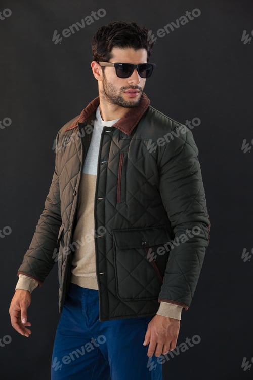 Preview: Man In Sunglasses Posing Against Black Background