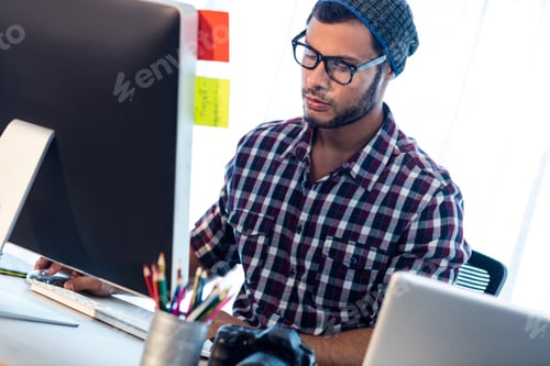 Preview: Photographer Working At Computer Desk In Studio