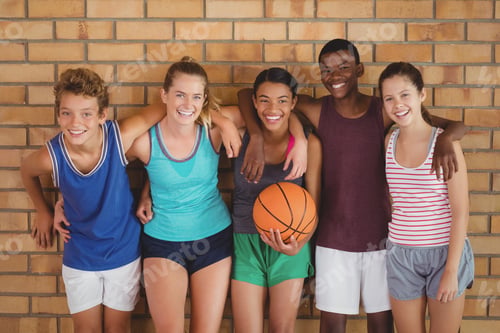Preview: Happy High School Kids With Arms Around Leaning Against The Wall In Basketball Court