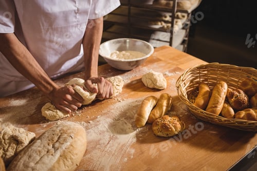 Preview: Mid-Section Of Baker Kneading A Dough In Bakery Shop
