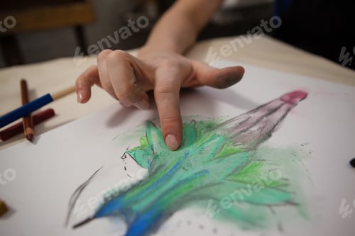 Preview: Close-Up Of Woman Shading In Drawing Book At Table
