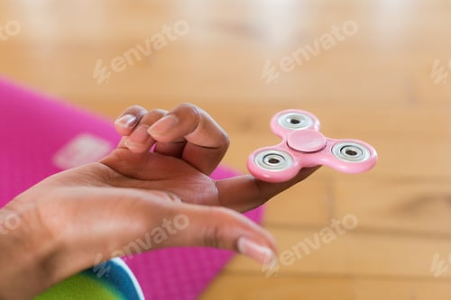 Preview: Girl Holding A Fidget Spinner In A Fitness Room