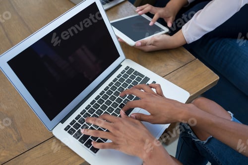 Preview: Executives Using Digital Tablet And Laptop Together In The Office