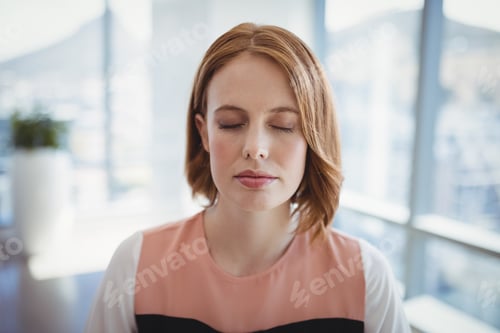 Preview: Close-Up Of Beautiful Executive Meditating In Office