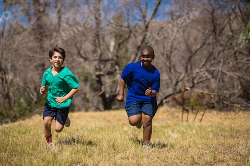 Preview: Friends Running On Grass During Obstacle Course In Boot Camp