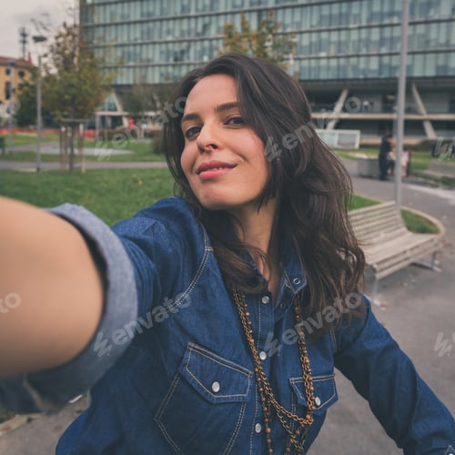 Preview: Pretty Girl With Long Hair Takes A Selfie In The City Streets