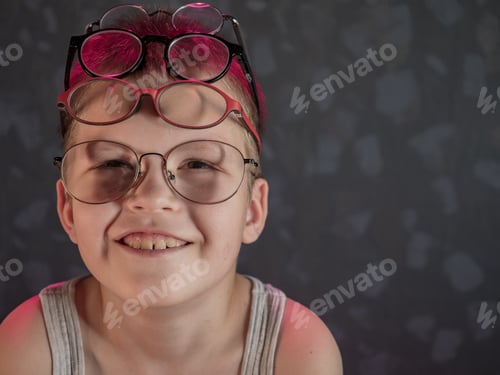 Preview: Photo Of Funny Kid With Many Pairs Of Glasses On Face