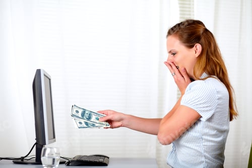 Preview: Portrait Of A Surprised And Excited Beautiful Girl Holding Plenty Of Cash Dollars In Front Office