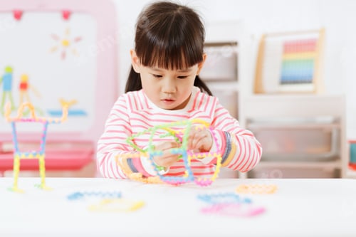 Preview: Young Girl Playing Creative 3D Shape Toy For Homeschooling