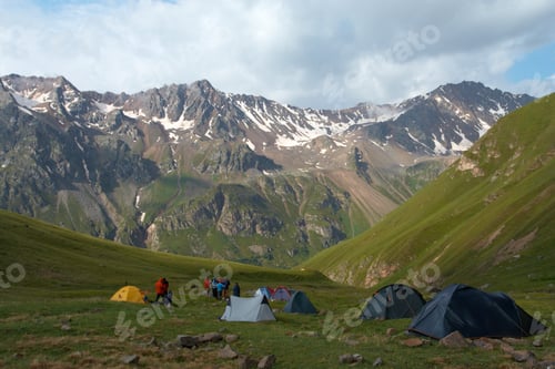 Preview: Hikers Resting Near The Tent At The Mountain Camp