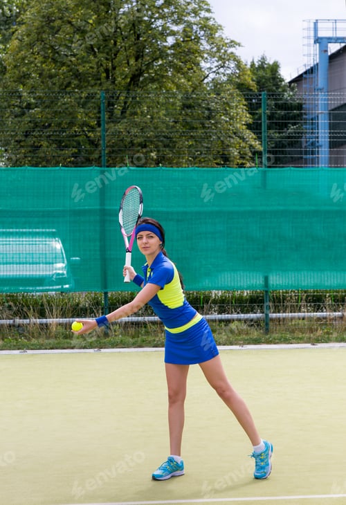 Preview: Young Attractive Female Tennis Player During A Game On A Court Outdoor In Summer Or Spring