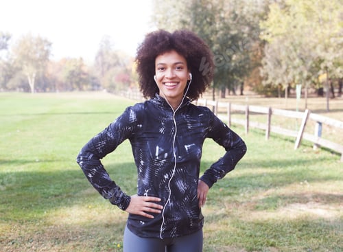 Preview: Portrait Of Afro Fitness Happy Woman Listening Music After Exercise In Nature And Ready For