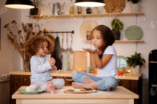Preview: Two Little Girls Prepare Christmas Cookies In The Kitchen