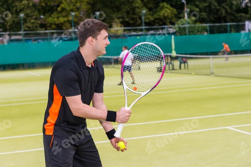 Preview: Male Tennis Player Wearing A Sportswear Is Ready To Throw Ball During A Match Outdoor On Tennis