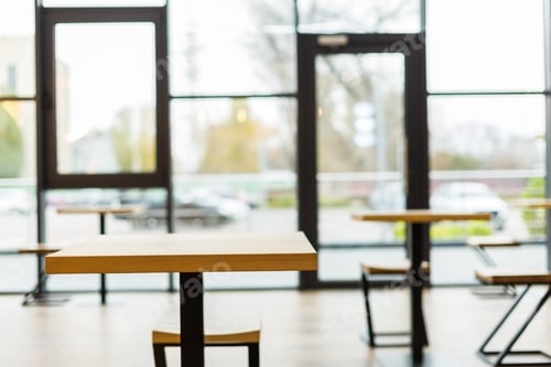 Preview: No Visitors. Close Up Of An Empty Table In The Cafeteria With A Big Glass Wall In The Background
