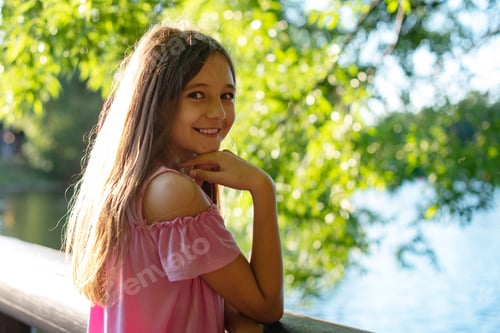Preview: Candid Portrait Of A Girl Near A Pond In The Sun Rays