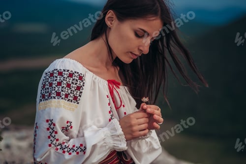 Preview: Attractive Woman In Traditional Romanian Costume On Mountain Green Blurred Background. Outdoor