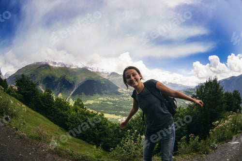 Preview: Young Happy Woman With Backpack Standing In Mountains In Georgia
