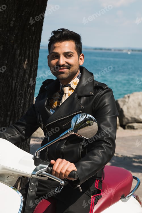 Preview: Handsome Indian Man Posing On A Scooter In A Vacation Context. Street Fashion And Style.