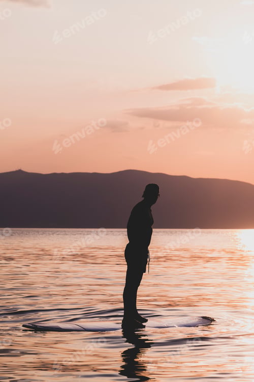 Preview: Sporty Young Man On Sup Paddle Board Going To The Sea At Sunset.