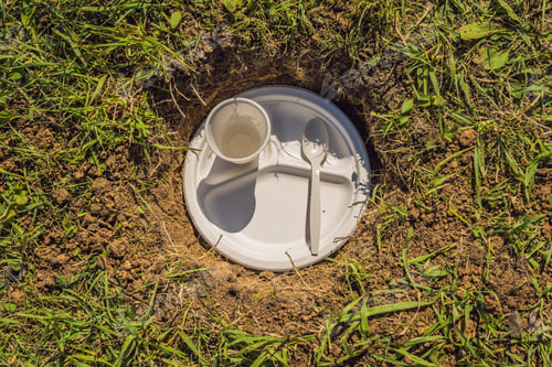 Preview: The Boy Plays Recycling. He Buries Plastic Disposable Dishes And Biodegradable Dishes