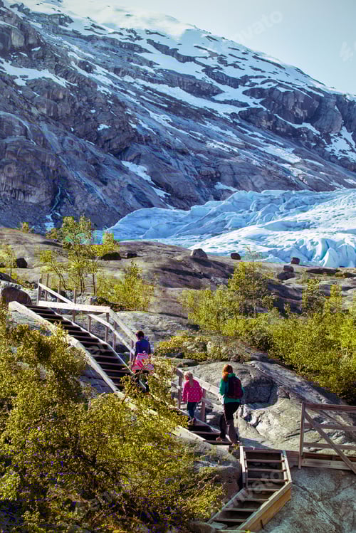 Preview: Mother And Sisters Hiking On The Lake With Mountains And The Glacier Nigardsbreen At The Background