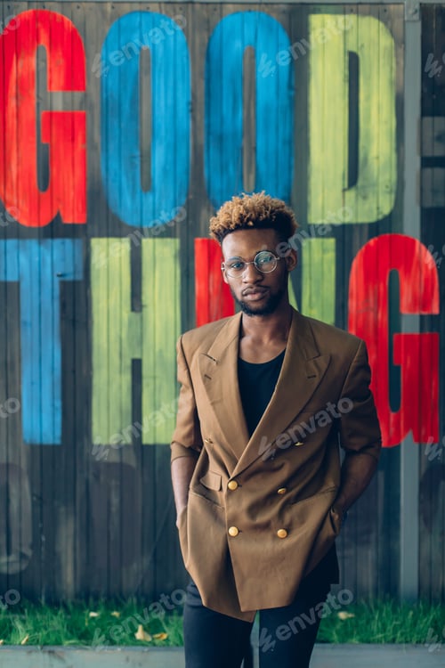 Preview: African American Man In A Jacket Near A Wooden Colored Wall