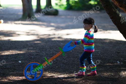 Preview: Young Girl Playing Outdoor Measure-Mate In The Forest Park For Leaning Measurement