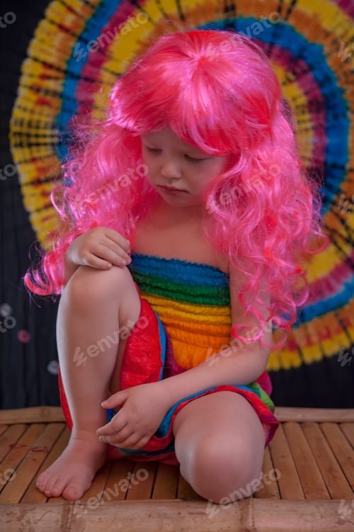 Preview: Happy Cute Caucasian Boy Changed Clothes At Carnival In Dress Of Girl Of Rainbow Color. Pink Doll
