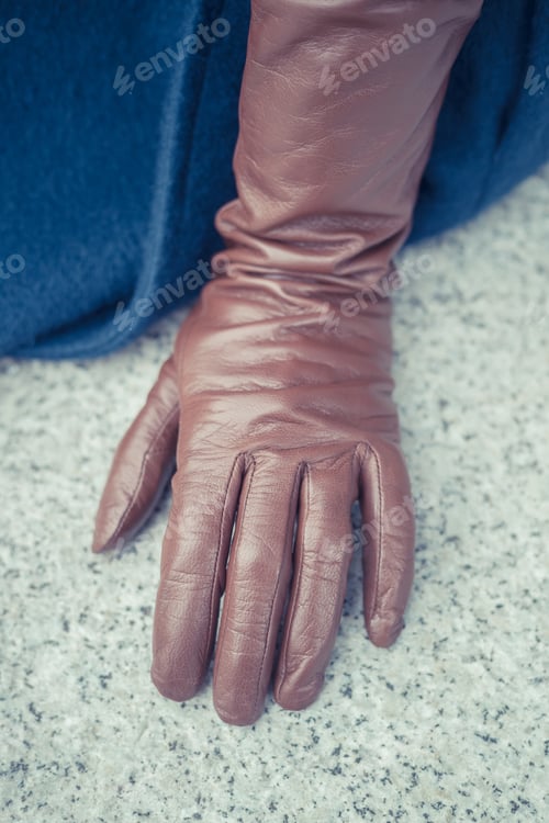 Preview: Brown Leather Glove on Gray Surface Close Up