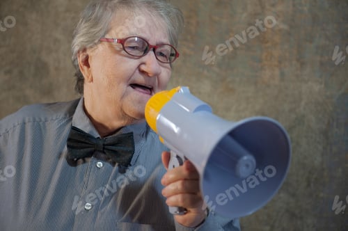 Preview: Beautiful Senior Woman Is Excited, Euphoric, Screaming With Megaphone, Sign Of Revolution And