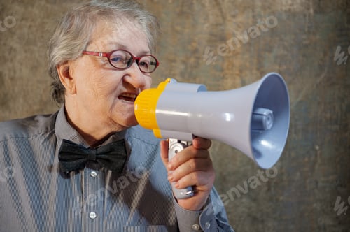 Preview: Beautiful Senior Woman Is Excited, Euphoric, Screaming With Megaphone, Sign Of Revolution And