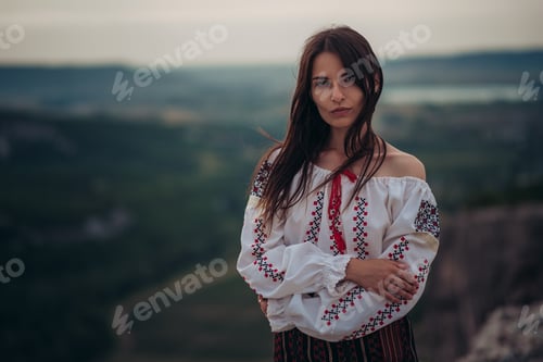 Preview: Attractive Woman In Traditional Romanian Costume On Mountain Green Blurred Background. Outdoor