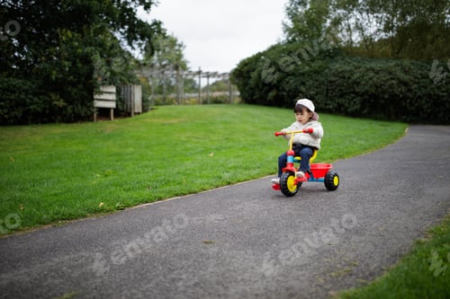 Preview: Baby Girl Play Bike In Summer Forest Park