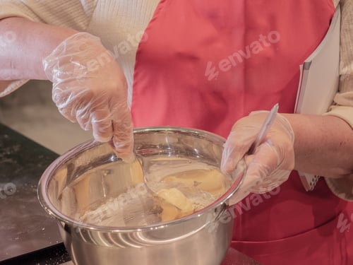 Preview: Cheerful Elderly Woman In Red Apron With Beautiful Wrinkled Face Process Of Preparing Eclairs At