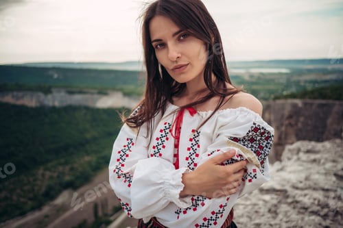 Preview: Attractive Woman In Traditional Romanian Costume On Mountain Green Blurred Background. Outdoor