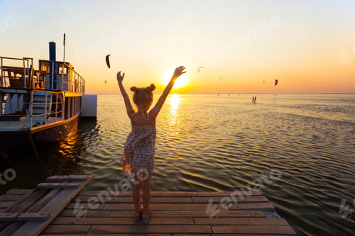 Preview: Girl On The Pier In The Background Of The Sea, Ship And Sunset. Ukrainian Landscape