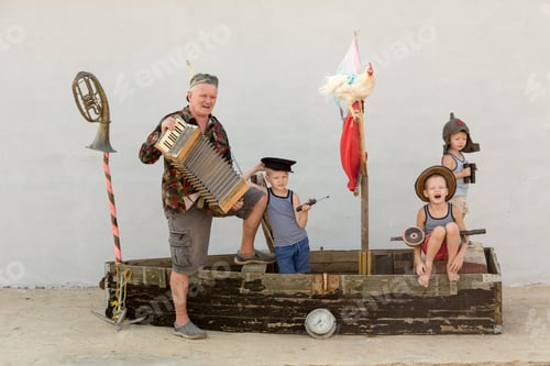 Preview: Three Cute Boys With Father On Pirate Ship As Sailors On Summer Evening. Children Have Fun
