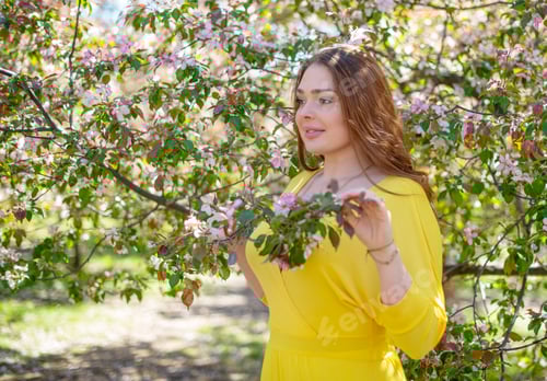 Preview: Beautiful Young Girl In Apple Orchard. Girl In Yellow Dress.