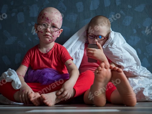 Preview: Caucasian Children In Pink T-Shirt With Smartphone On Floor. Boys Posing For Camera Under White