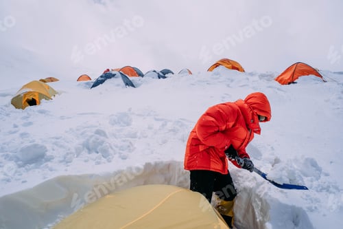 Preview: Man Cleaning Tent Of Snow In Mountains