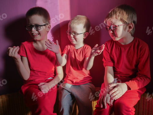 Preview: Funny Children In Red Clothes Posing In Front Of Camera. Boys Actively Express Their Emotions
