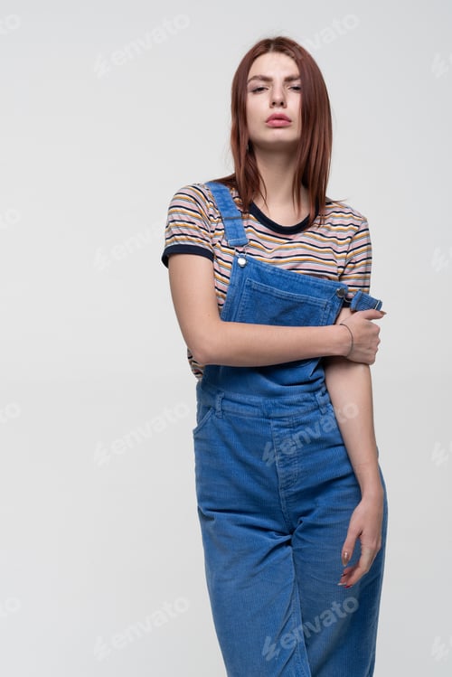 Preview: Young Beautiful Girl Stands In Blue Overalls